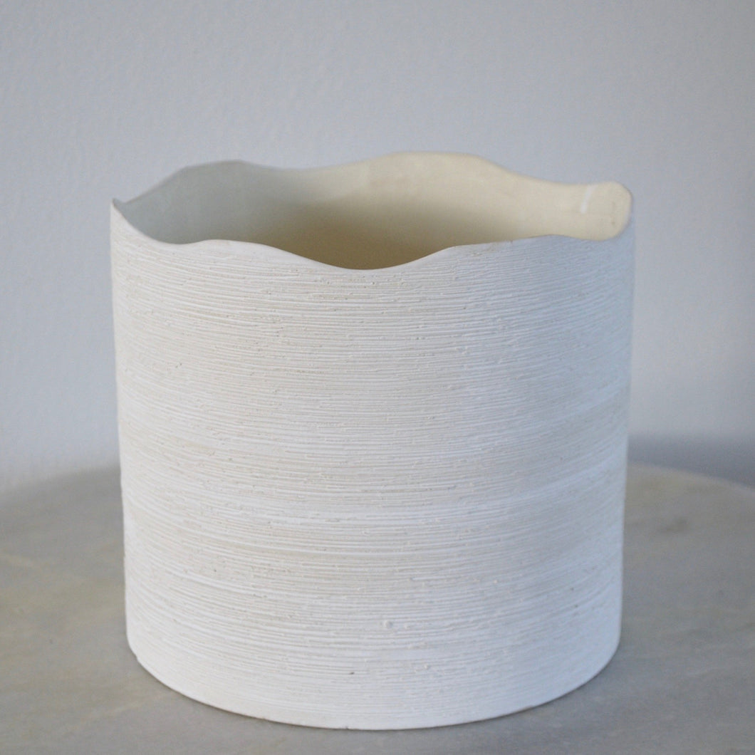 white pot with wavy opening