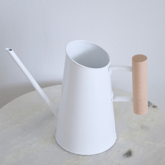 white sleek watering can with wood handle
